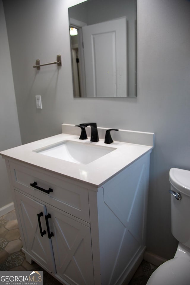 bathroom featuring vanity and toilet