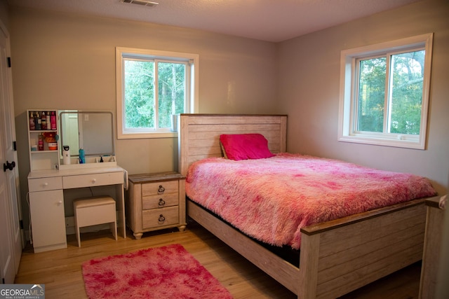 bedroom with light hardwood / wood-style flooring