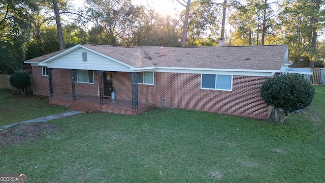 exterior space featuring a porch and a front yard