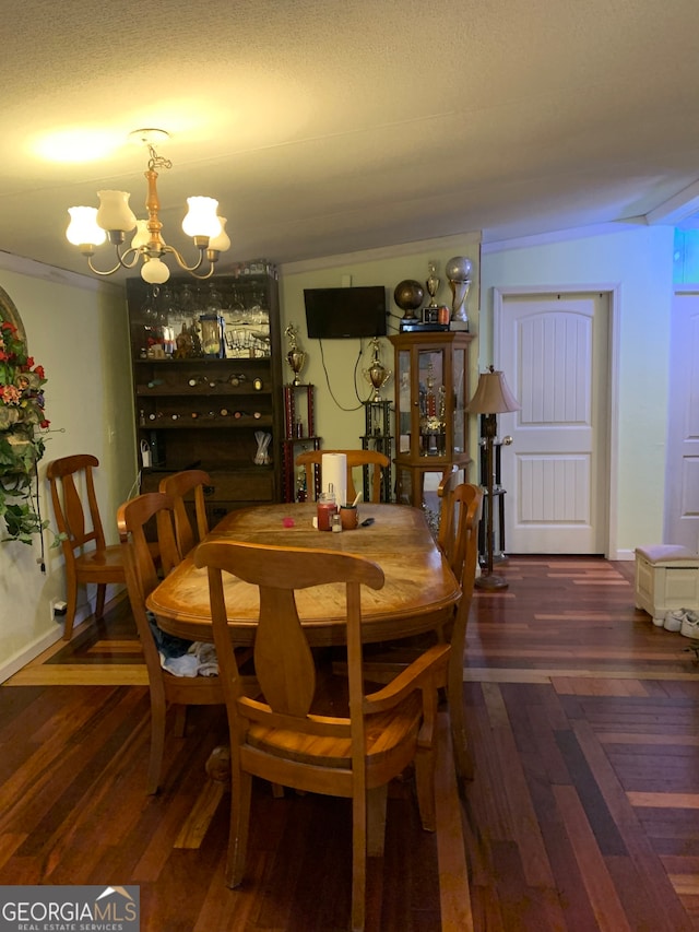 dining room featuring dark wood-type flooring and a notable chandelier