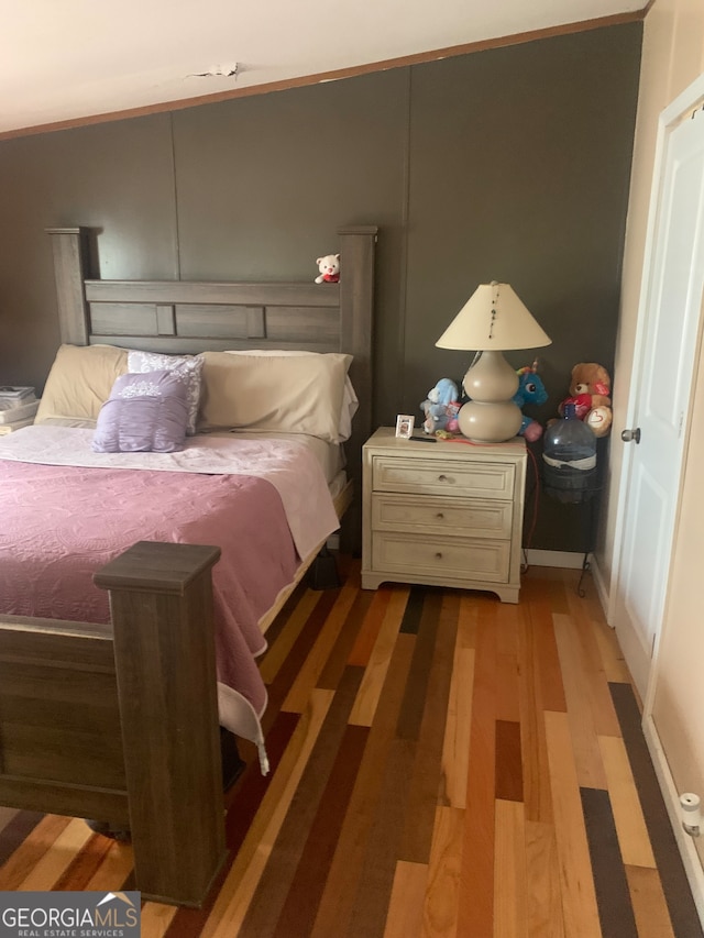 bedroom with hardwood / wood-style flooring