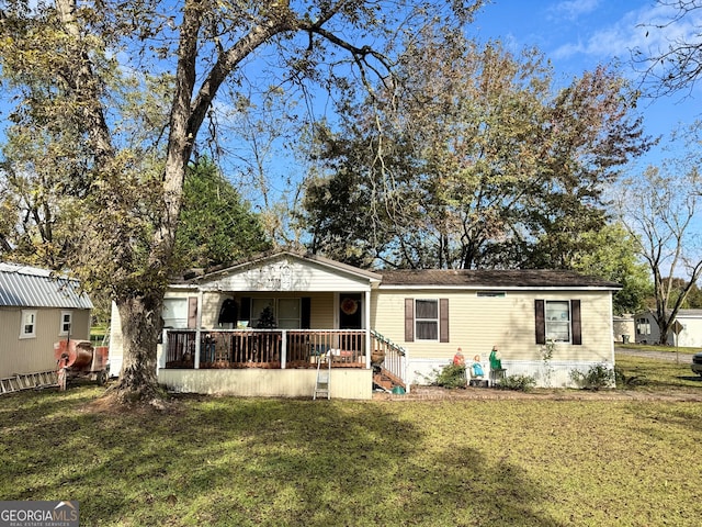 view of front of home with covered porch and a front yard