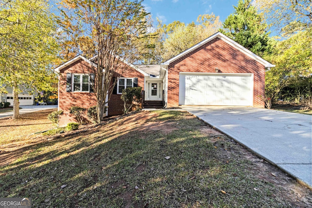 ranch-style house featuring a garage and a front yard