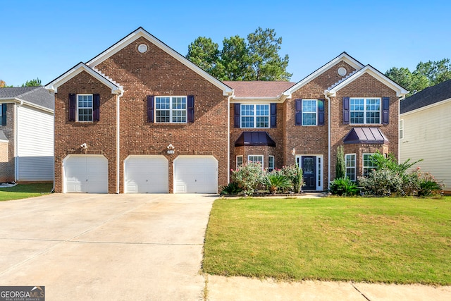 view of front of house with a front lawn and a garage