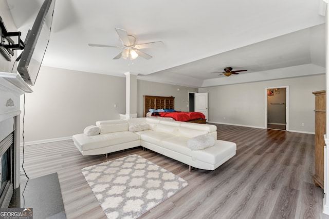 living room with ornate columns, ceiling fan, and hardwood / wood-style floors