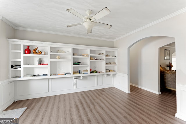 interior space featuring ceiling fan, ornamental molding, and light hardwood / wood-style flooring