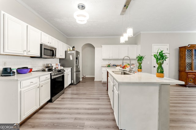 kitchen with sink, light hardwood / wood-style flooring, an island with sink, white cabinetry, and stainless steel appliances