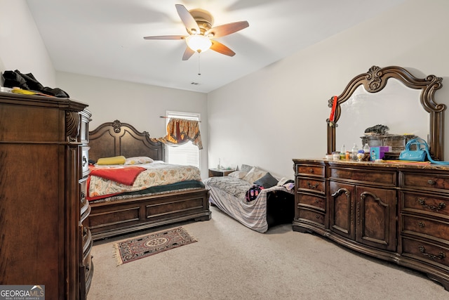 bedroom featuring ceiling fan and light carpet