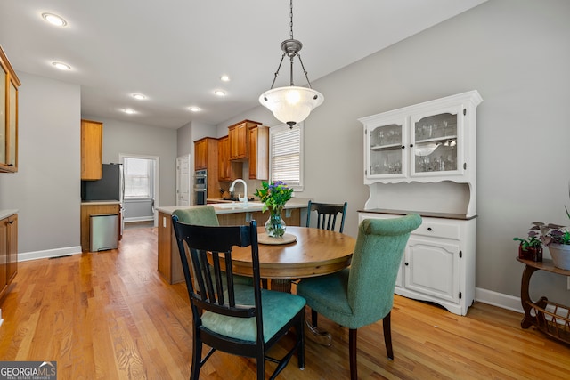 dining space featuring sink and light hardwood / wood-style floors