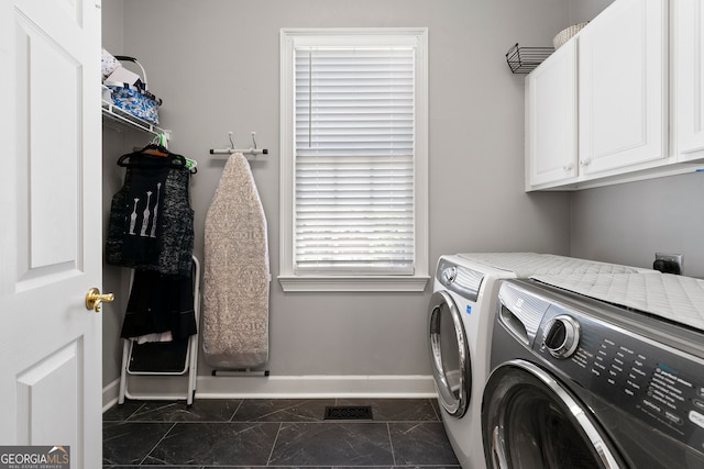 laundry room with cabinets and separate washer and dryer