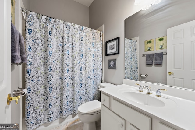 bathroom with tile patterned flooring, vanity, and toilet