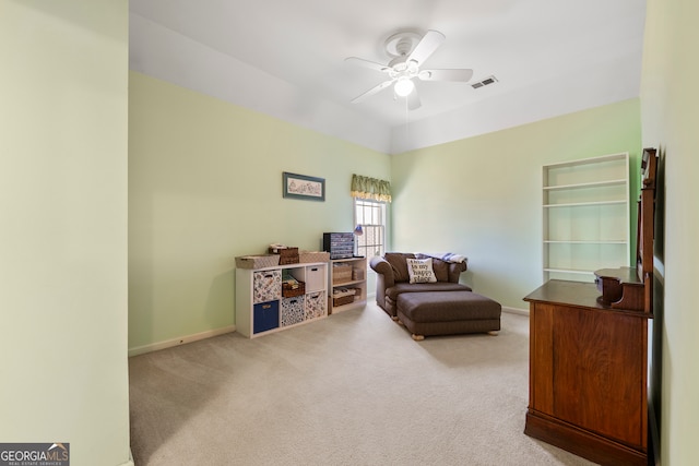 sitting room with light carpet and ceiling fan