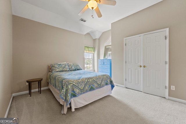 carpeted bedroom featuring ceiling fan, a closet, and lofted ceiling