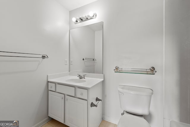 bathroom featuring tile patterned flooring, vanity, and toilet