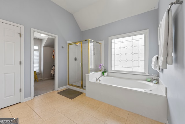 bathroom featuring tile patterned flooring, separate shower and tub, a wealth of natural light, and vaulted ceiling