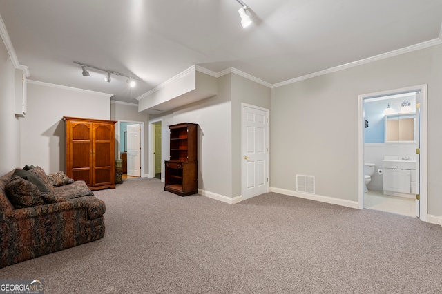 living area with sink, carpet floors, ornamental molding, and track lighting