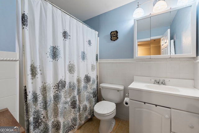 bathroom featuring vanity, tile patterned flooring, a shower with shower curtain, toilet, and tile walls