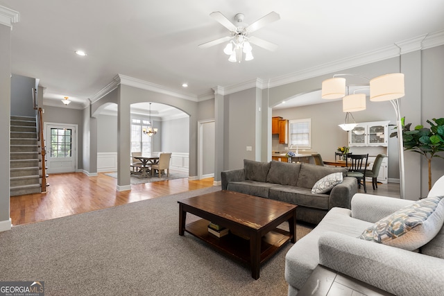 living room featuring crown molding, ceiling fan, and wood-type flooring