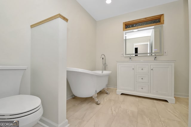 bathroom featuring vanity, toilet, and a tub