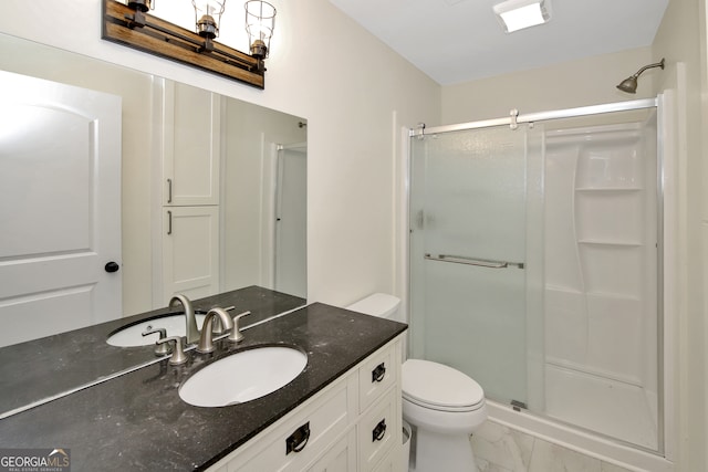 bathroom featuring vanity, toilet, and walk in shower