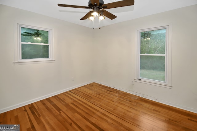 unfurnished room featuring hardwood / wood-style flooring and ceiling fan