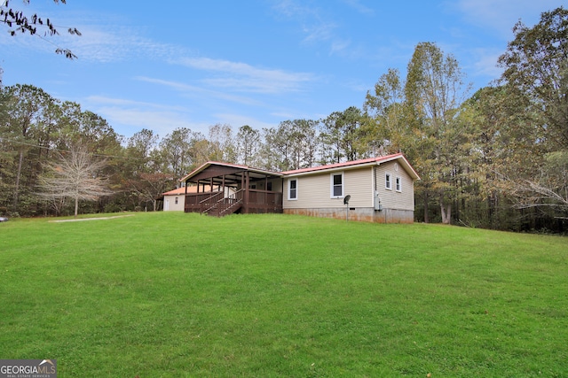 rear view of property featuring a yard