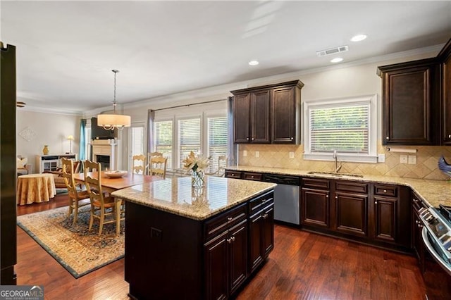 kitchen featuring a wealth of natural light, sink, dark wood-type flooring, and appliances with stainless steel finishes