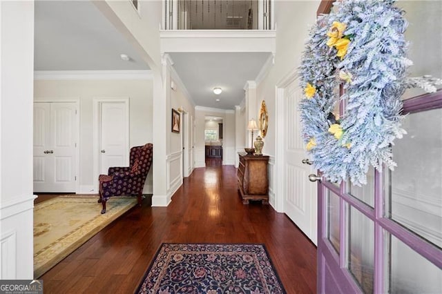 entryway featuring crown molding and dark hardwood / wood-style floors