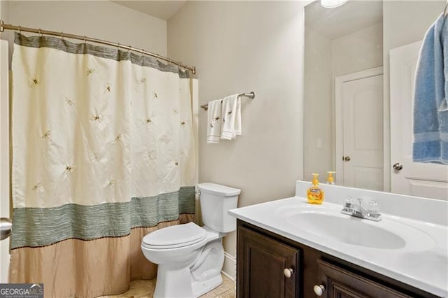 bathroom featuring tile patterned floors, vanity, toilet, and walk in shower