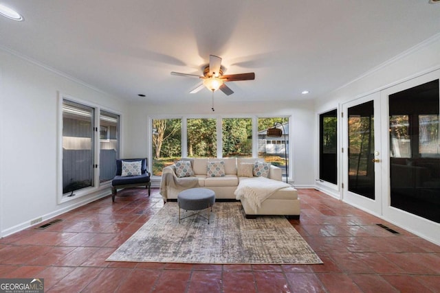 living room featuring french doors, dark tile patterned floors, ceiling fan, and ornamental molding