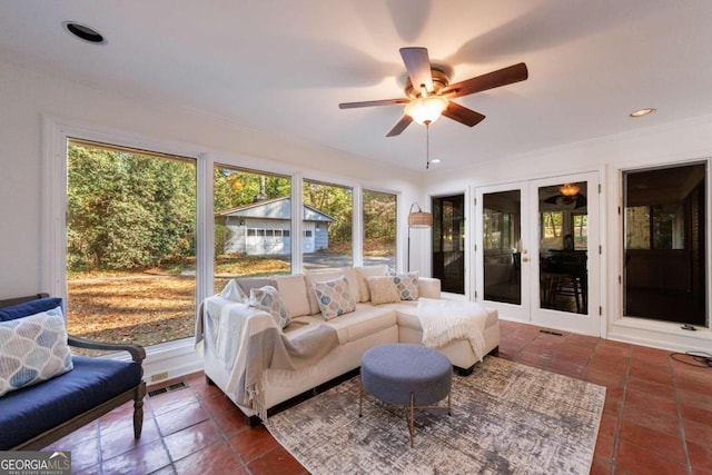 sunroom with ceiling fan and french doors