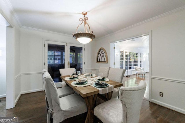 dining room with dark hardwood / wood-style floors, ornamental molding, and french doors