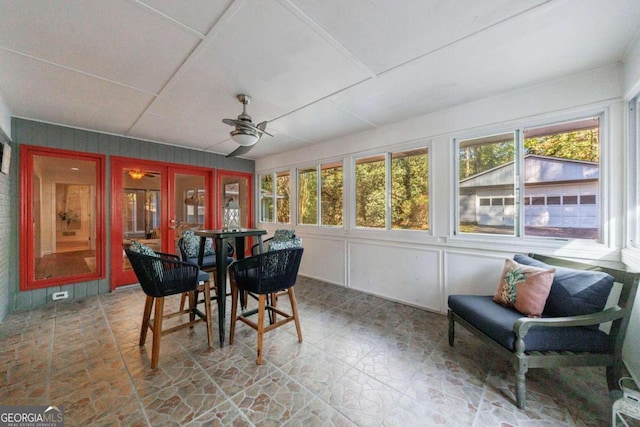 sunroom / solarium featuring ceiling fan and a healthy amount of sunlight