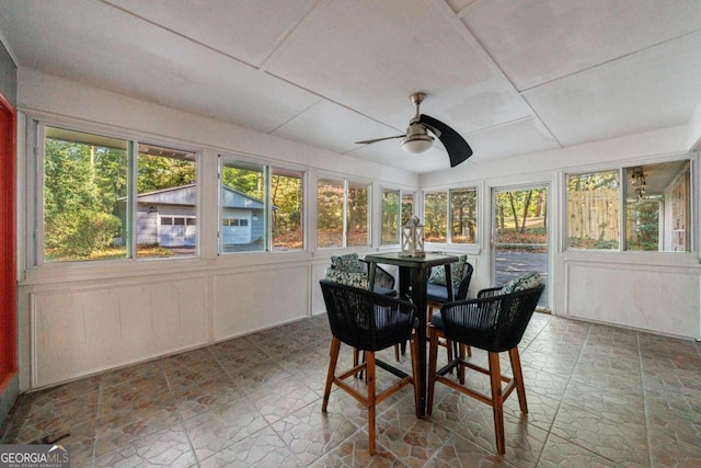 sunroom / solarium featuring ceiling fan