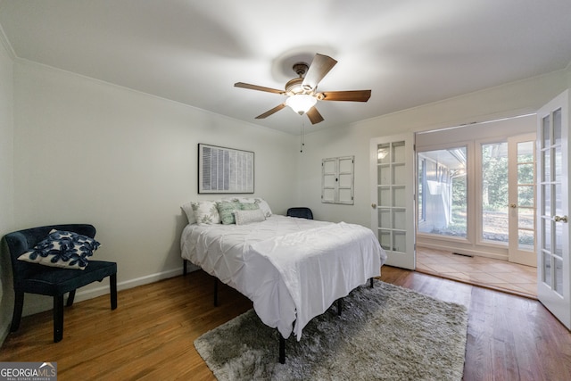 bedroom with ceiling fan, wood-type flooring, and french doors