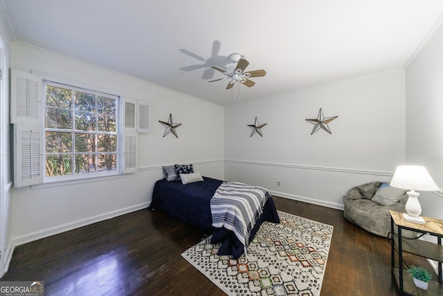 bedroom with ceiling fan, dark hardwood / wood-style flooring, and crown molding