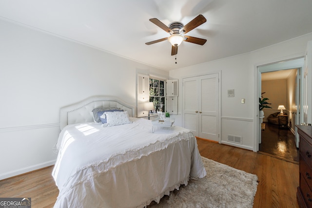 bedroom featuring hardwood / wood-style floors, a closet, and ceiling fan