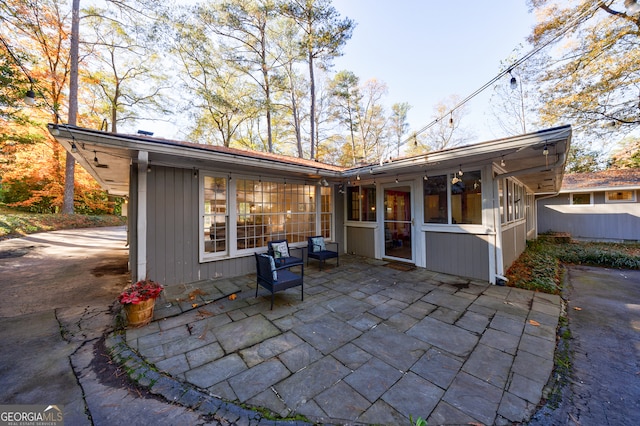 back of house featuring a patio area and a sunroom