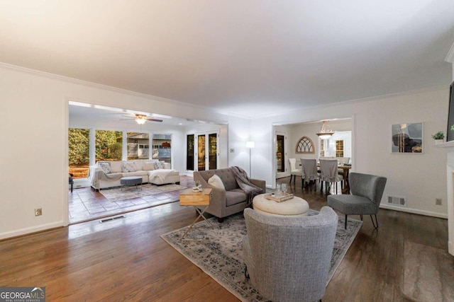 living room featuring crown molding, ceiling fan, and wood-type flooring