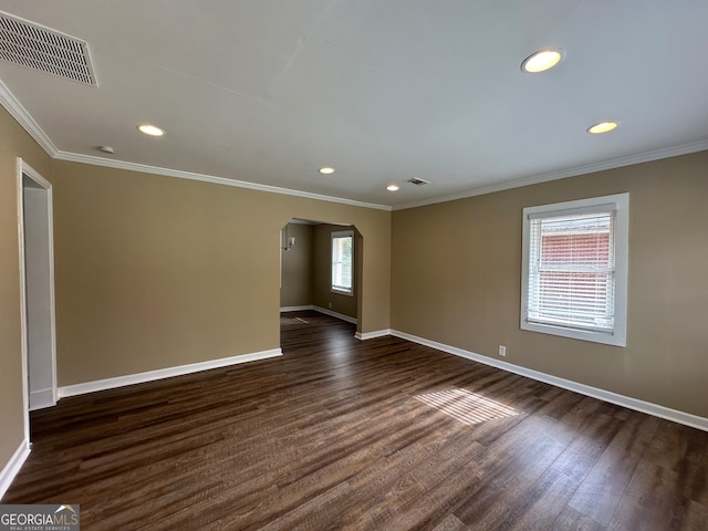 spare room with dark hardwood / wood-style floors and ornamental molding