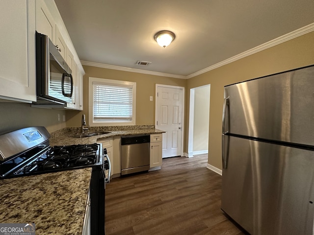 kitchen featuring light stone countertops, stainless steel appliances, and white cabinetry