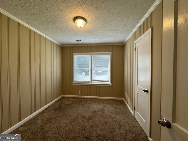 carpeted spare room with crown molding and a textured ceiling