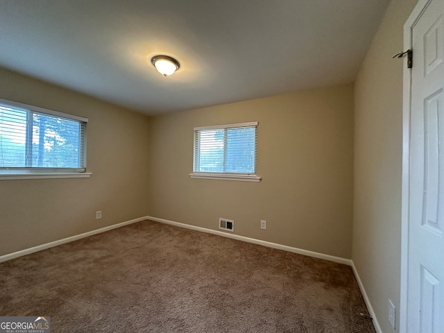 unfurnished room with carpet flooring