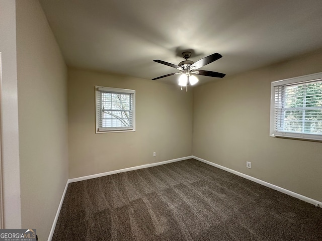 carpeted empty room with ceiling fan and a healthy amount of sunlight