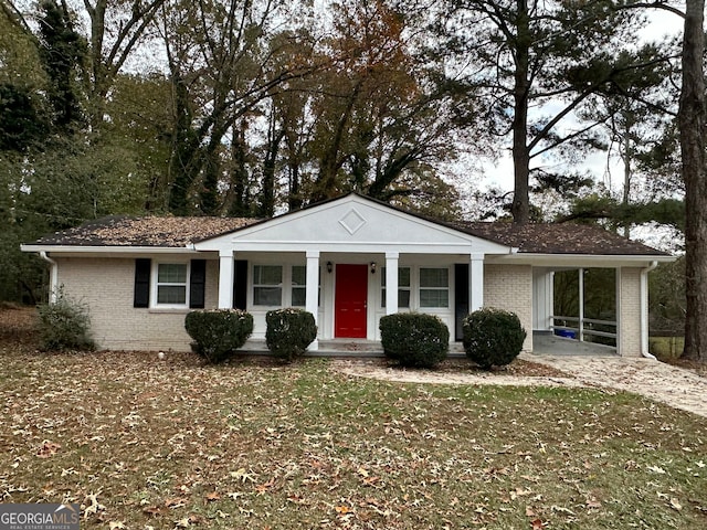 ranch-style home with a carport and covered porch