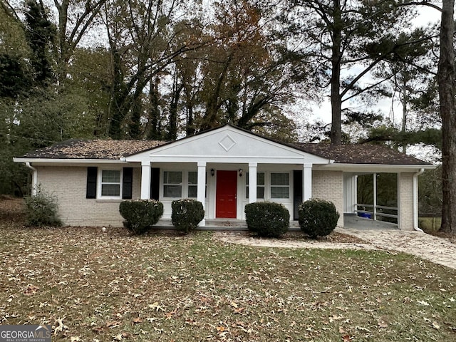 4433 Mercer Rd, Decatur, GA 30035 - view of front of house featuring brick siding, an attached carport, driveway, and covered porch
