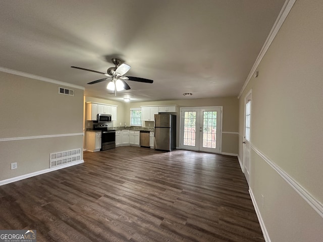 unfurnished living room featuring dark hardwood / wood-style floors, ceiling fan, crown molding, and french doors