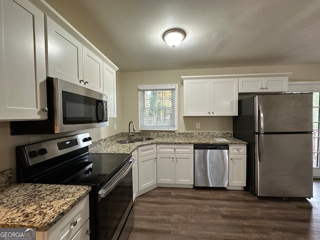 kitchen featuring white cabinetry, stainless steel appliances, and dark wood-type flooring