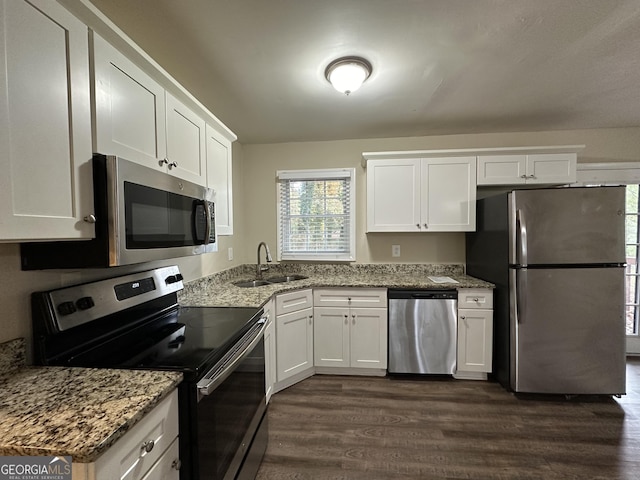 4433 Mercer Rd, Decatur, GA 30035 - kitchen featuring appliances with stainless steel finishes, a sink, dark wood-type flooring, white cabinets, and light stone counters