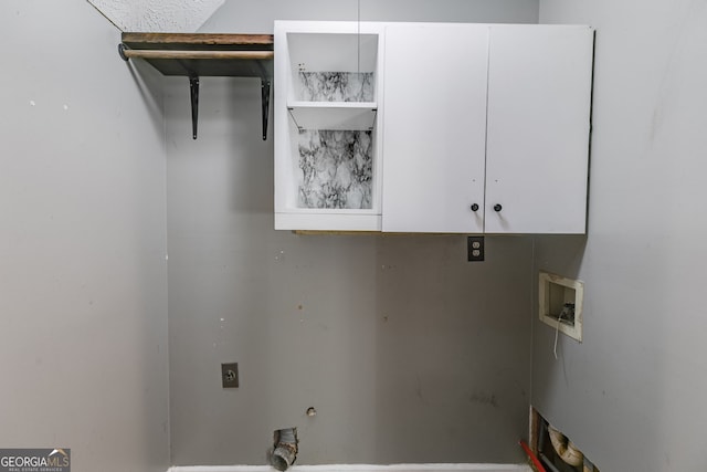 clothes washing area with hookup for an electric dryer, cabinets, and hookup for a washing machine